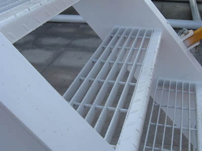 Several swage-locked steel grating treads form a stair.